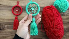 someone is holding yarn in their hands and crocheting it into a dream catcher