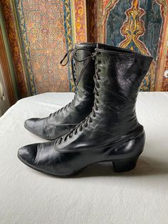 These classic suffrage era shoes are in marvelous shape for their age. With a profile of an ankle high bootie, the lace up, pointed toe styling is identified as a "must have" for authentic women's costuming for historic correctness. I find both shoes to be in comfortable, wearable condition. The soft leather has significant wear on the tongue, but still laces well and feels comfortable to use. It fits my size 7.5 generously, although I do have a naturally slim foot and would call them a "narrow" size. The real stacked leather heel and heavy leather sole also have significant wear, with one shoe probably needing repair within a season of use. If used for rare costume dates (my recommendation for antique leather)  these shoes should last through quite a few fantastic dressy events. Vintage Fitted Cap Toe Boots, Fitted Cap Toe Vintage Boots, Fitted Vintage Cap Toe Boots, Historical Formal Boots With Leather Sole, Classic Fitted Boots With Low Heel, Victorian Boots With Leather Sole For Formal Wear, Victorian Boots With Leather Sole, Victorian Formal Boots With Leather Sole, Formal Victorian Boots With Leather Sole