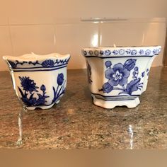 two blue and white bowls sitting on top of a counter