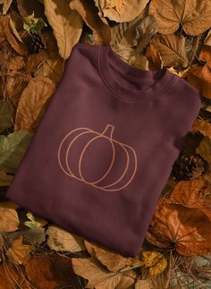 Get cozy and stylish with our charming sweatshirt featuring an adorable embroidered orange pumpkin design! This pre-shrunk, classic fit sweatshirt is perfect for autumn days, Halloween festivities, or any pumpkin lover. Elevate your seasonal wardrobe with this pumpkin-themed sweatshirt bound to keep you warm in the colder months.  * 50% cotton, 50% polyester * Pre-shrunk * Classic fit * 1x1 athletic rib knit collar with spandex * Air-jet spun yarn with a soft feel and reduced pilling * Double-needle stitched collar, shoulders, armholes, cuffs, and hem Basic Cotton Sweater For Fall, Orange Cotton Sweatshirt For Fall, Orange Crew Neck Sweatshirt For Fall, Embroidered Pumpkin, Embroidered Orange, Pumpkin Sweatshirt, Seasonal Wardrobe, Halloween Festivities, Pumpkin Sweatshirts