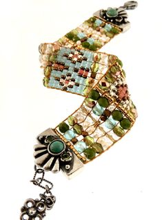 CHILI ROSE OF SANTE FE (Adonnah Langer) This sterling silver beaded bracelet was designed and made by Adonnah Langer of Chili Rose Beadz. Her rich colors and intricate designs are made with Czech glass and delicate beads of all shapes and colors. The sterling silver lobster and chain make this bracelet adjustable. -Gorgeous Floral Turquoise Sterling Silver End Tips Mix of Turquoise soft Pastels & Freshwater pearl Adjustable to approximately 7 3/4 inches -Sterling handcrafted chain with "flow Artisan Czech Glass Jewelry Bracelet, Artisan Czech Glass Bracelet, Elegant Handmade Beaded Bracelets For Festivals, Bohemian Beaded Bracelets With Bead Caps As Gift, Silver Beaded Bracelets With Unique Variations, Artisan Silver Beaded Bracelets With Unique Variations, Fusion Style Beaded Bracelets For Gifts, Bohemian Bracelets With Bead Caps For Gifts, Unique Silver Beaded Bracelets With Colorful Beads