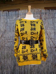 Here is a vintage 80s sweater.  Black floral design with silver threading.  Cute sweater!  Belt not included.  Measurements Bust: 44 in. Waist: hangs at 34 in. and pulls to 40 in. Shoulder to Shoulder: aprox 17 in. Length: 28 in. Flower Widget Medium, Flower Widget, Widget Medium, The 80s Fashion, 80s Sweater, Pullover Outfit, Womens Sweaters, Floral Sweater, Long Sleeve Print Dress