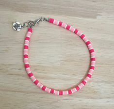 "Add that extra pop to any outfit this summer with this bright coral pink anklet! The anklet is made with an array of coral pink colored polymer beads and finished with a charm of your choice! Colors may vary from image. The anklet is available in a variety of sizes, just message me for custom sizes or an adjusted extender length! There is a size for everyone! :)  * All anklet sizes selected from the drop down menu are the size of the anklet without the 1/4\" chain extender. When selecting a siz Cheap Pink Anklets For Festivals, Cheap Pink Round Beads Anklets, Pink Tiny Beads Anklets For Summer, Pink Anklets With Tiny Beads For Summer, Coral Beaded Bracelet For The Beach, Pink Beaded Anklets For Summer, Pink Beaded Summer Anklets, Casual Pink Anklets For Summer, Casual Pink Anklet For Summer