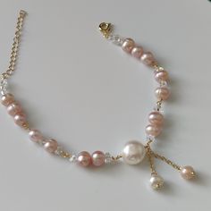 This is a super attractive bracelet made of natural baroque pearls and crystals. The natural luster of the p  earls is moist and shiny. The crystals with the faceted face attract a lot of attention.  Size   ：White Pearl 10+ mm / Pink Pearl 6+mm Colour  ：white and pink         （The colour of the pearls are all natural colors, not artificially added）  Material：Fresh water Pearl Bridesmaid Pearl Bracelet, Bead Accessories, Pink Pearl Bracelet, Om Shanti, Pearl Jewellery, Freshwater Pearl Bracelet, Necklace Design, Bridesmaid Bracelet, Natural Pearl