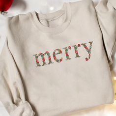 a white sweatshirt with the word merry on it