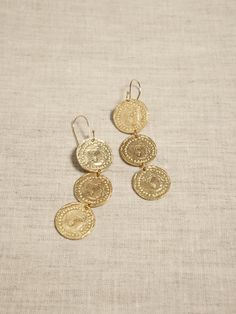 Motif Coin Trio Earrings | Aureus + Argent | Banana Republic Banana Republic Jewelry, Tarnish Resistant Brass Medallion Jewelry, Spiritual Brass Jewelry With Coin Pendant, Spiritual Brass Coin Pendant Jewelry, Gold Coin Pendant Brass Jewelry, Gold Brass Coin Pendant Jewelry, Ceremonial Brass Jewelry With Coin Pendant, Yellow Gold Brass Pierced Jewelry, Antique Gold Engraved Earrings