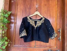 Hand embroidered ready made saree blouse / crop top/stitched saree blouse usa / saree blouse/modern blouse/zardosi blouse/ black handwork  saree blouse/ pure silk black blouse/ maggam work blouse        It is very true that a perfect blouse is the one which makes your saree look stand out !! If you find one of such a style that you have been wanting to have then dont let it go !! we carry such unique trending blouses that instantly add a stylish look to any saree !!     Well..!! we understand that you may not get in your desired size/pattern/color, here you go with customization according to your size/pattern which we can deliver in 1-2 weeks of time period !!      Here is a beautiful Hand embroidered zardosi work saree blouse in black color that has High neck with hand embroidery design a Saree Blouse Modern, Black Hand Embroidery, Zardosi Blouse, Hand Embroidery Blouse, Handwork Saree, Modern Blouse, Ready Made Blouse, Maggam Blouse, Hand Embroidered Blouse