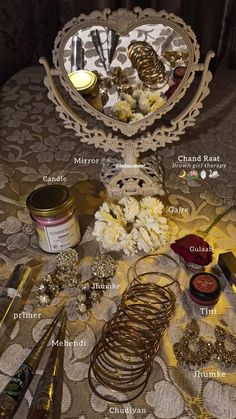 the table has many different types of jewelry and other items on it, including candles