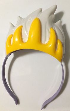 a yellow and white headband with horns on it