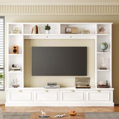 a white entertainment center with bookshelves and a flat screen tv mounted on the wall