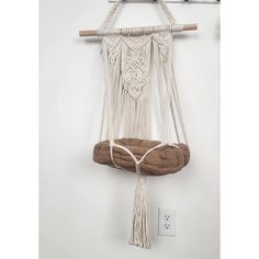 a macrame hanging on a wall with a light switch