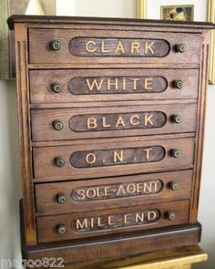 an old wooden cabinet with some writing on it's drawers and the words clark white black on it