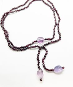 "Lariat garnet necklace with chunky amethyst beads.  Versatile piece to wrap and tie around your neck or waist or wrist.  43\" in long" Adjustable Lariat Crystal Necklace With Gemstone Beads, Adjustable Hand-strung Lariat Necklace, Adjustable Lariat Jewelry With Gemstone Beads, Adjustable Lariat Necklace With Gemstone Beads, Elegant Hand-strung Lariat Necklace, Lariat Beaded Necklaces With Natural Stones For Jewelry Making, Bohemian Lariat Necklace With Faceted Beads, Adjustable Long Lariat Necklace With Faceted Beads, Elegant Adjustable Lariat Necklace With Gemstone Beads