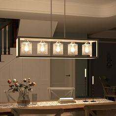 a dining room table and chairs with lights hanging from the chandelier above it