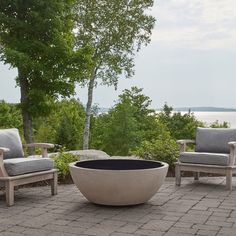 an outdoor fire pit sitting on top of a brick patio