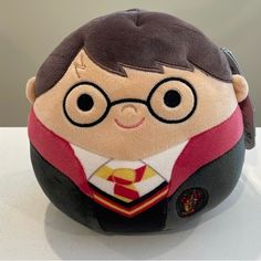 a harry potter stuffed animal with glasses and tie