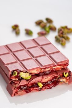 a bar of chocolate with pistachios next to it