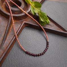 This is a dainty beaded necklace in a combination of small dark red garnet stones and tiny peach pink seed beads with a subtle shimmery finish. The stones are separated from the glass beads by small solid sterling silver etched Hill Tribe beads. The necklace is finished with a solid sterling silver spring ring clasp. You can add an optional silver plated 2-inch extender chain for added versatility or peace of mind if this is a gift. This modern necklace gives you a fun pop of color. It's lightweight and the optional extender chain would make it easy to layer with some other faves. Necklace length: 16 inches; optional 2" extender chain available Your necklace will arrive in an eco-friendly Kraft paper gift box. Beaded Necklace Collection: https://www.etsy.com/shop/BonArtsStudio?ref=seller-p Rose Gold Necklaces With Round Tiny Beads, Burgundy Beaded Necklaces With Round Beads As Gift, Handmade Burgundy Beaded Necklaces As Gift, Handmade Burgundy Beaded Necklaces For Gifts, Handmade Burgundy Necklaces With Round Beads, Amber Beaded Necklaces With Spacer Beads As Gift, Layering Jewelry, Modern Necklace, Necklace Collection