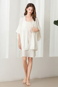 Fabric: 92% 19 Momme mulberry silk 8% Spandex Color: White Care: Hand wash or dry clean Silk robe dressing gown. Dolman sleeves. Shawl collar. Dropped shoulders. Open front. Fastens with a matching belt. Closing edge. Unlined. This wrap is designed with kimono proportions, but with a more modern short length. Elegant Solid Silk Sleepwear, Elegant V-neck Sleepwear For Lounging, Silk V-neck Kimono For Daywear, Elegant Satin Loungewear, Elegant Satin Sleepwear For Lounging, Fitted Silk Sleepwear With Long Sleeves, Fitted Silk Long Sleeve Sleepwear, Elegant V-neck Robe For Daywear, Silk Fitted Robe For Loungewear