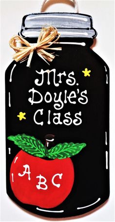 a chalkboard sign that says mrs dokie's class with an apple on it