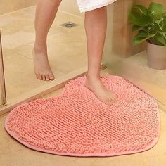 a person standing on a bathroom rug in front of a mirror