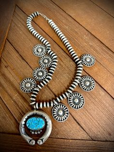 What a magnificent piece of jewelry. .925 sterling silver Native American handcrafted squash style necklace by artist Tom Lewis. It has amazing handmade Navajo pearls and all silver conchos along with a beautiful turquoise stone inside of the silver naja. 20" long Tom Lewis, Secret Of Life, Navajo Pearls, Kids Earrings, Style Necklace, Barbie Girl, Turquoise Stone, Earring Necklace, Vintage Watches