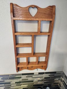 a wooden shelf hanging on the wall above a stove