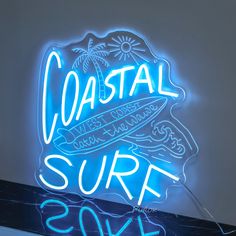 a neon sign that says coastal surf soak