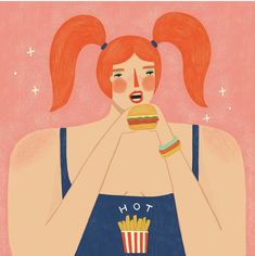 a woman with red hair eating a hamburger and fries