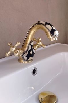 the faucet is gold and black in color