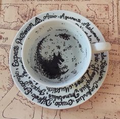 a cup with writing on it sitting on top of a map