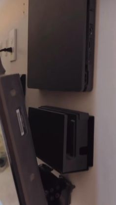 there is a tv that is hanging on the wall next to other things in the room