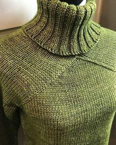 a green turtle neck sweater on a mannequin