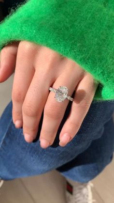 a close up of a person's hand with a ring on top of their finger