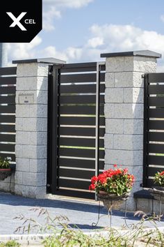 two flower pots sitting next to each other on the side of a building with a black gate