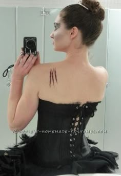 a woman in a corset taking a selfie in front of a mirror