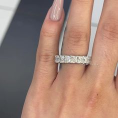 a woman's hand with a diamond ring on it