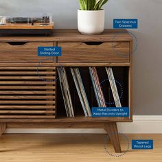 an old record player has been turned into a sideboard with vinyl records and tape recorders