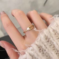 🌸 Introducing Our Fashion Buckle Ring! 🌸 Add a touch of Fashion and charm to your style with our delightful Minimalistic geometrical Pearl Ring! Crafted with love and care, this adorable accessory is a must-have for any fashionista looking to elevate their style game. ✨ Colors: ✨ Gold 🌟 Material: 🌟 Made from high-quality Titanium Steel, ensuring durability and a brilliant shine that lasts. Artificial Pearl 🎀 Adjustable Size: 🎀 Ring Sizes  06-09 💖 Key Features: 💖 Adorable geometrical desi Trendy Simple Jewelry As A Gift, Trendy Simple Design Jewelry For Gifts, Minimalist White Metal Ring, Minimalist White Metal Rings, Trendy Wedding Midi Rings, Trendy Simple Ring Jewelry, Trendy Gold Pearl Ring Gift, Trendy Simple Design Ring Jewelry, Trendy Open Ring Midi Rings For Wedding