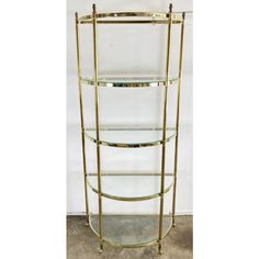 a brass and glass shelf with three shelves