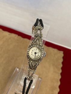 Vintage Elegant 1950's Bucherer Ladies Swiss Made Marcasite Watch from .800 Swiss Euro Silver and Marcasite Settings. This beautiful ladies wristwatch is in Excellent vintage condition. All the stones are intact, it winds and runs. extra nice Braided Silk 6.25 inches in length 9/16 inch diameter Silver Case 2 inches in length 1/2 inch wide marked CB 800 on back grade 9/10 The mineral marcasite, sometimes called white iron pyrite, is iron sulfide with orthorhombic crystal structure and can be Fac Timeless Collectible Jewelry With Round Dial, Antique Diamond Watch For Evening, Hallmarked Vintage Jewelry For Evening, Vintage Hallmarked Jewelry For Evening, Vintage Diamond Watch With Jubilee Bracelet For Evening, Antique Silver Diamond Watch, Vintage Engraved Diamond Watch As Gift, Vintage Engraved Diamond Watch For Gift, Vintage Evening Diamond Watch With Jubilee Bracelet