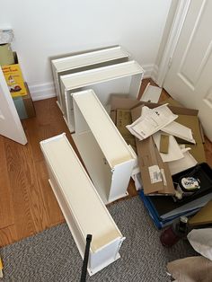 boxes are piled up on the floor in front of a door and some other items