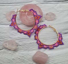 Handmade beaded hoop earrings with a unique tribal shape, these earrings feature a unique shape with a multicolored pattern inside. They were inspired by the shapes seen in art and architecture of Mesoamerican civilizations and the beautiful hot pink Frangipani flowers that grow there. They are another addition to the Daughters of collection. These hoops are depicted in a vibrant pink and purple motif but can be custom ordered in many colors. Alternate sizes can also be custom ordered. Feel free Unique Handmade Small Hoop Jewelry, Handmade Geometric Multicolor Jewelry, Unique Beaded Hoop Jewelry, Traditional Handmade Hoop Earrings For Festivals, Unique Handmade Geometric Jewelry, Bohemian Beaded Hoop Earrings For Festivals, Unique Small Hoop Earrings For Festivals, Handmade Traditional Hoop Earrings For Festivals, Multicolor Teardrop Hoop Earrings