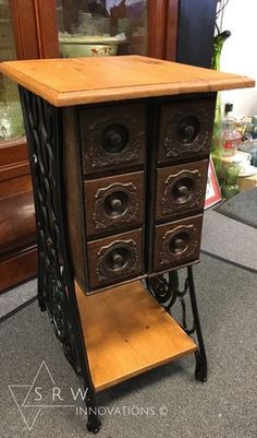 an antique wooden cabinet with four drawers