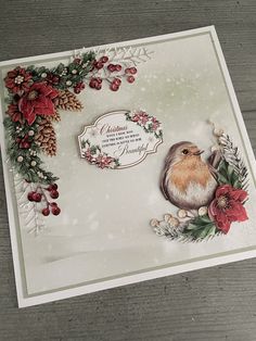 a christmas card with a bird and poinsettis