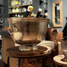 a large metal bowl sitting on top of a wooden table