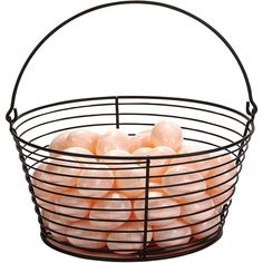 a wire basket filled with oranges on top of a white background