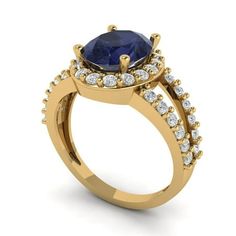 a yellow gold engagement ring with a blue sapphire and diamonds on the side, set in 18k yellow gold