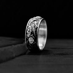 a silver ring sitting on top of a wooden floor