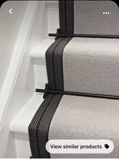 two black and white carpeted stairs with handrails